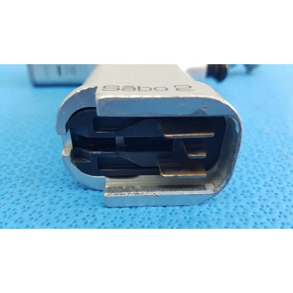 Silver metal electrical connector with black internal components engraved sabo 2 on the stryker sago surgical orthopedic reciprocating saw