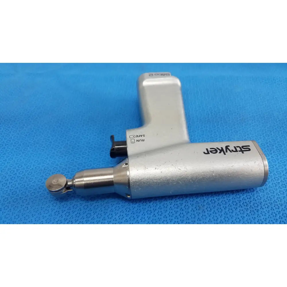Silver stryker sago 2 surgical orthopedic reciprocating saw with metallic finish and black safety switch