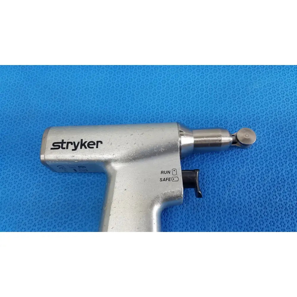 Silver stryker sago 2 surgical orthopedic reciprocating saw with metallic finish and black safety switch power tool