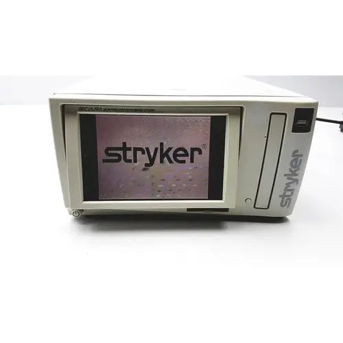 Stryker sdc ultra hd information management system with beige casing and black screen displaying the Stryker logo