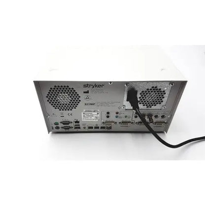 Back view of white stryker sdc ultra hd information management system featuring metallic panel with ventilation grilles and ports