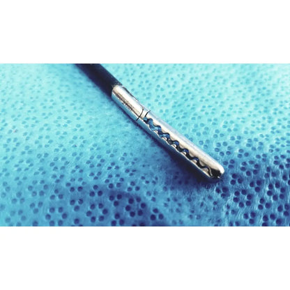 A sleek stryker stainless steel laparoscopiic clamp with a black handle and wavy serrated silver shaft