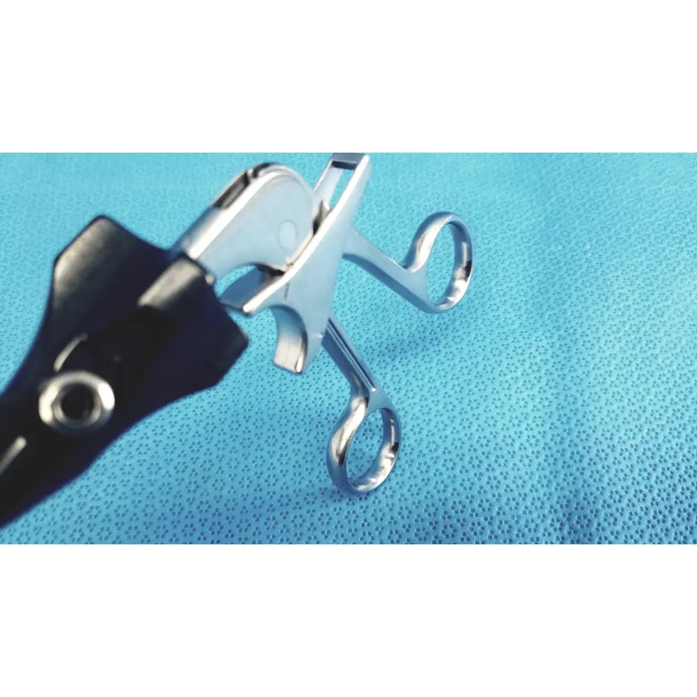 Silver stryker stainless steel laparoscopiic clamp with black ergonomic handle for surgical use