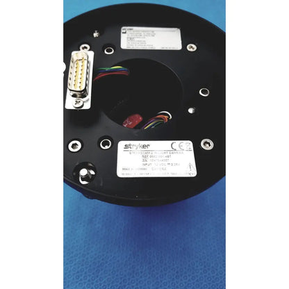 Black circular base of Stryker Strykecam 2 in-light camera with metallic connectors and color-coded wires visible from back side