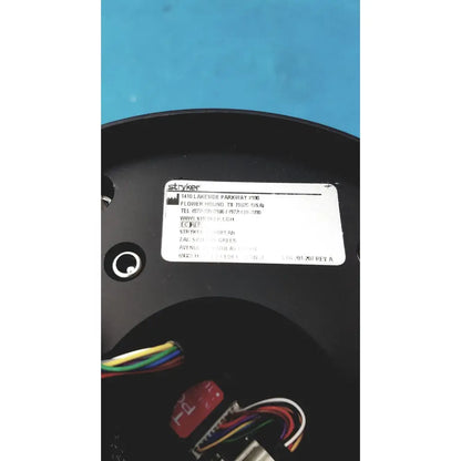 Black plastic circular base with white label showing stryker brand and contact info on stryker strykecam 2 in- light camera