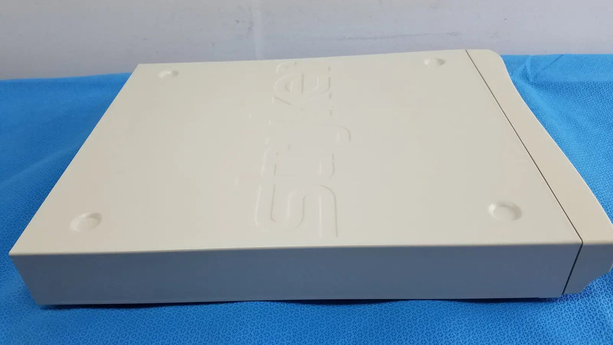 Cream-colored plastic playstation 2 console with embossed logo and circular indentations for Stryker Suite Stream HD Codec