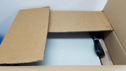 A sleek light gray stryker suite stream hd codec device with minimalist design inside an open cardboard box