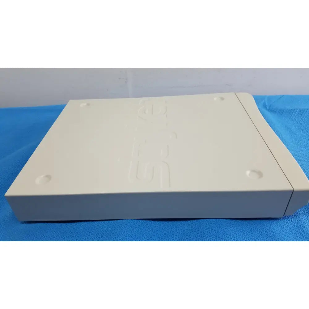 Cream-colored plastic playstation 2 console with embossed logo and circular indentations for Stryker Suite Stream HD Codec