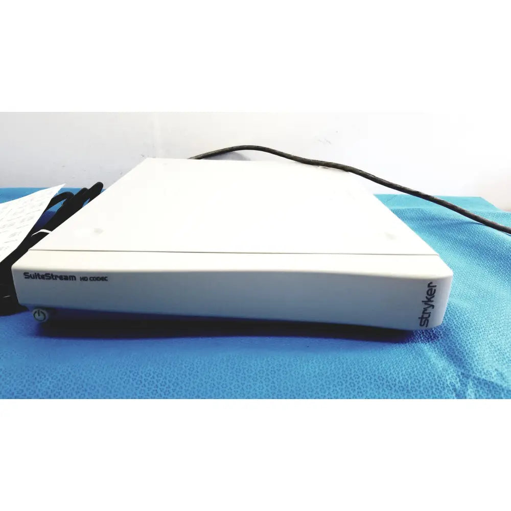 White rectangular stryker suite stream hd codec device with black branding and power button on front edge model 0678001200