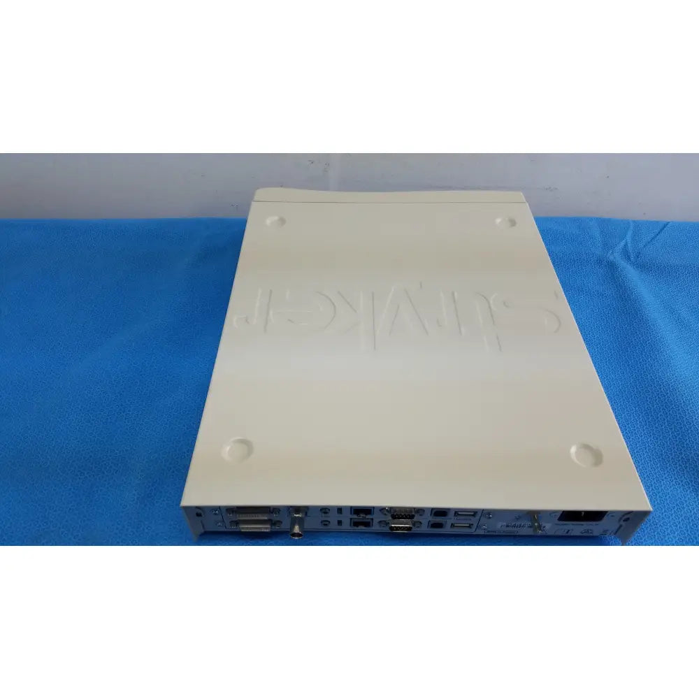 Cream-colored plastic stryker suite stream hd codec with embossed hikvision logo and multiple ports on rear panel
