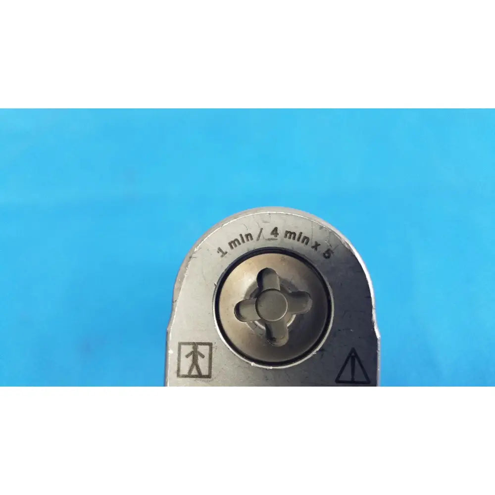 Silver metal pipe threading die with engraved markings and cross-shaped center for reuse medical orthopedic instruments