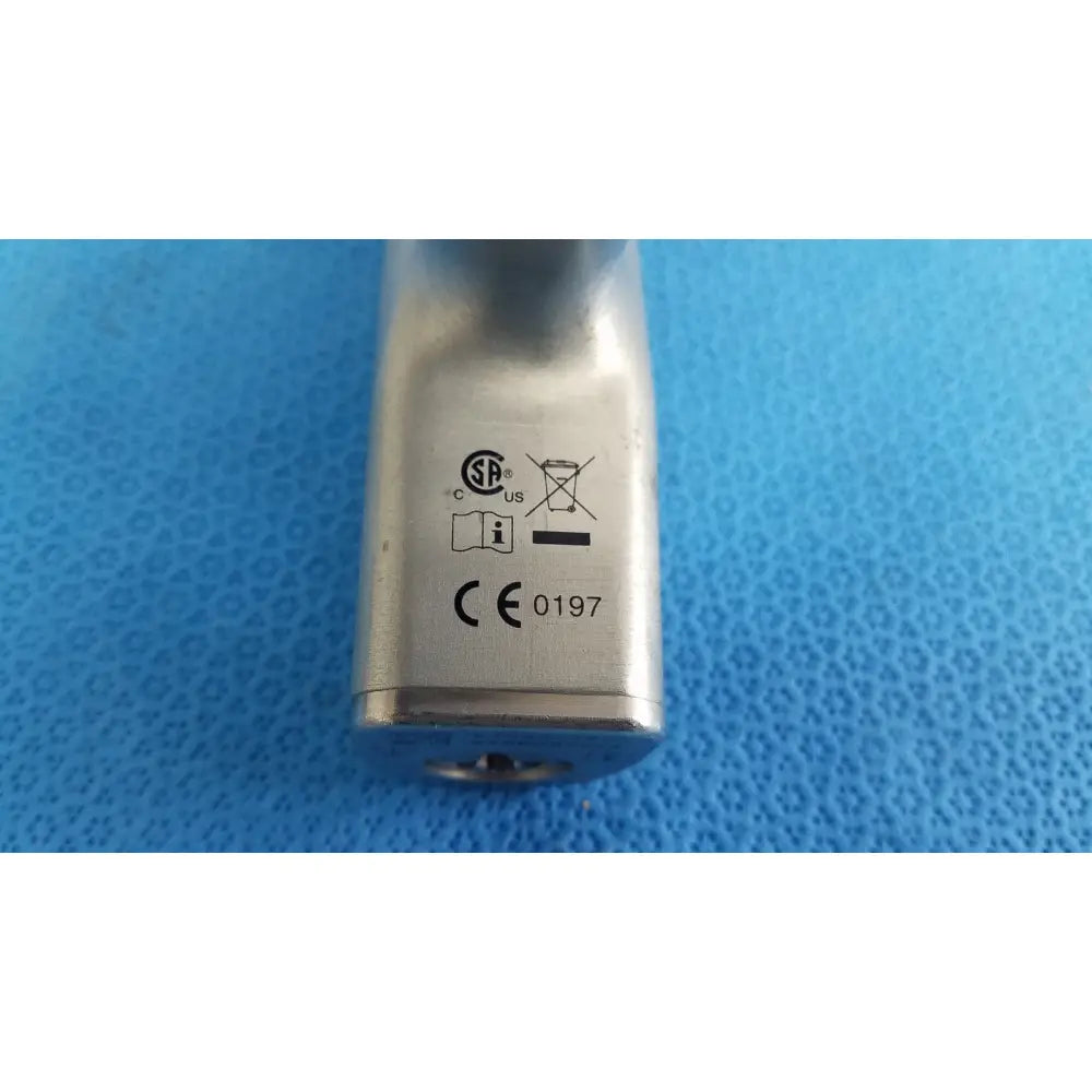 Silver metallic cylindrical lock with engraved certification marks and keyhole for reuse medical orthopedic instruments