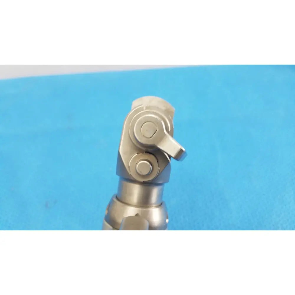 Silver metallic universal joint with polished finish and bolted connections for stryker system 7 sagittal saw handpiece reuse medical orthopedic instruments