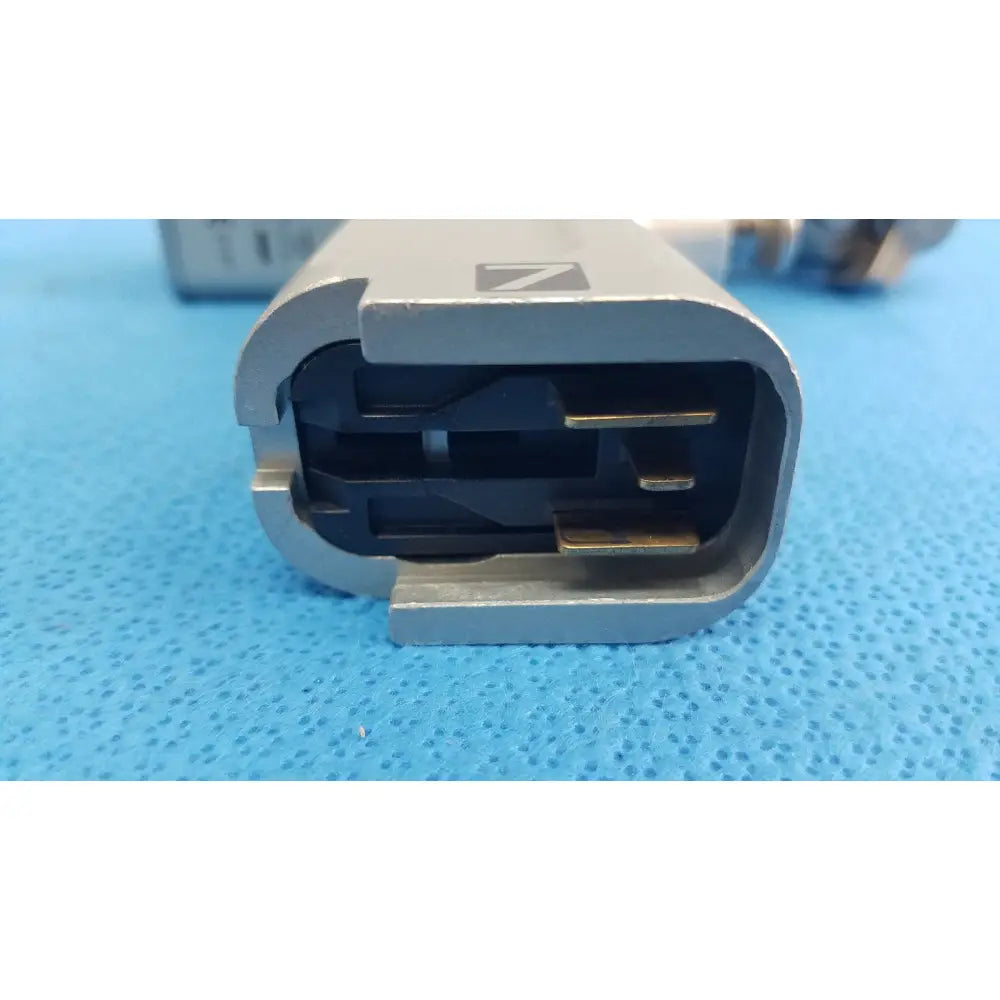Silver sennheiser earphone charging cable connector with black contacts and matte finish for reuse medical orthopedic instruments