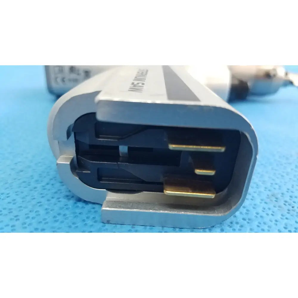 Silver-colored metal power connector with black housing and gold-plated pins for reuse medical orthopedic instruments sstryker system 8 sternum saw