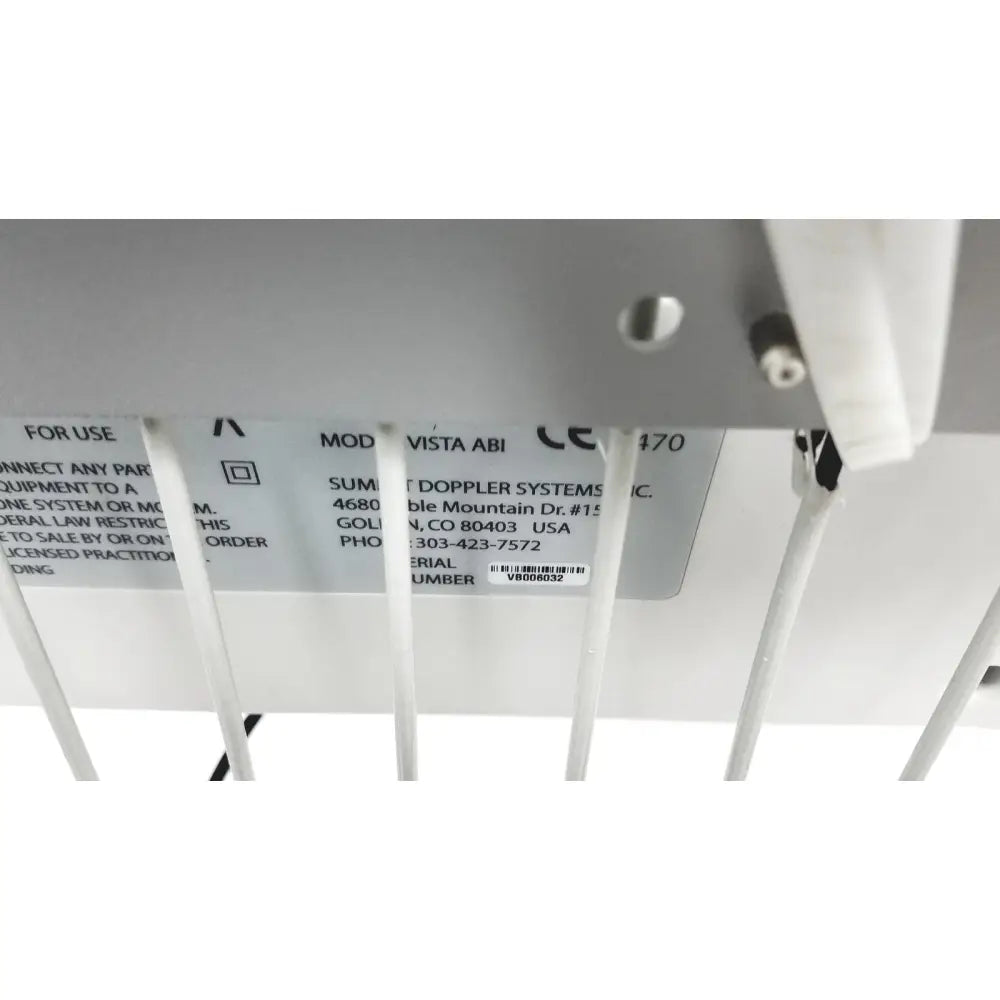 White plastic label with black text and barcode on underside of summiit doppller vista abi reuse medical device back side