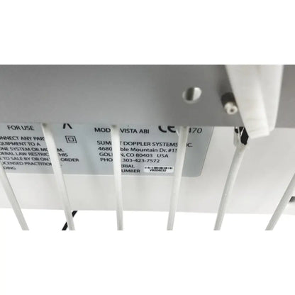 White plastic label with black text and barcode on underside of summiit doppller vista abi reuse medical device back side