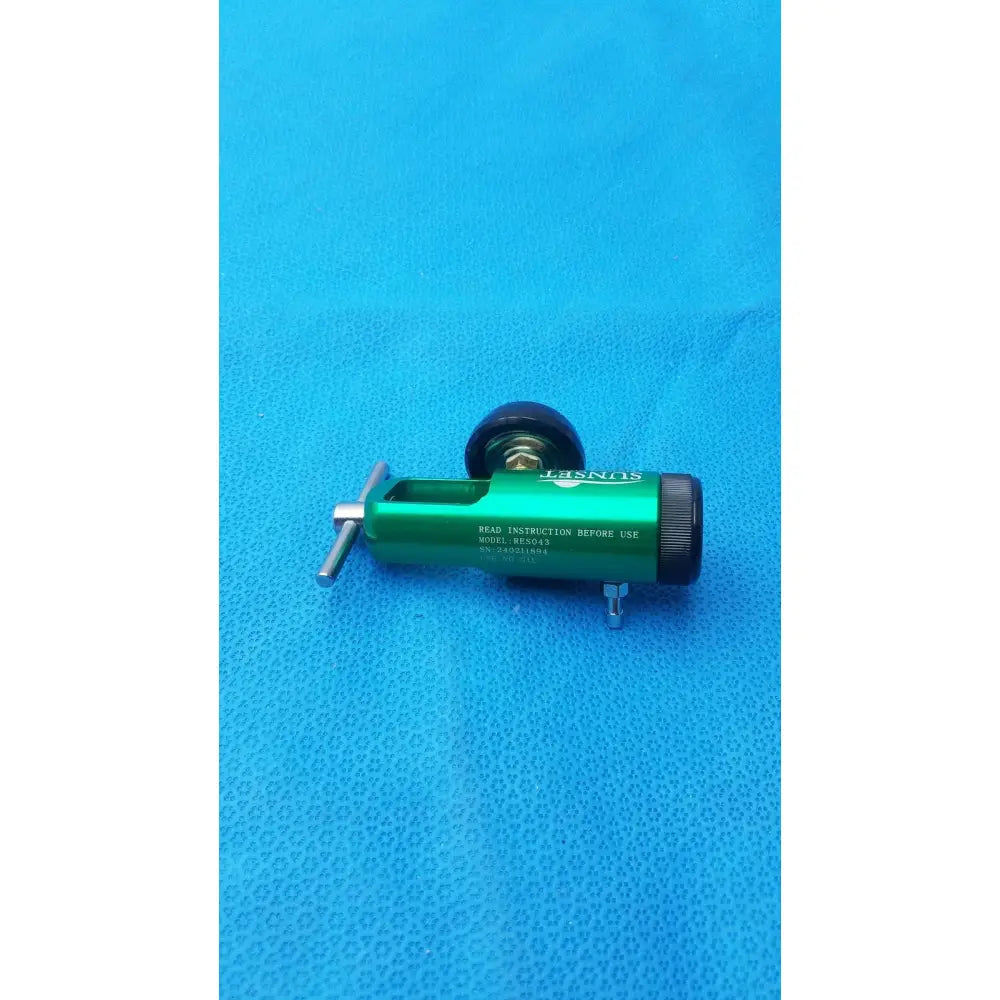 Green metallic sunset brass integral oxygen concentrator with black caps and silver adjustment knob for o2 regulation