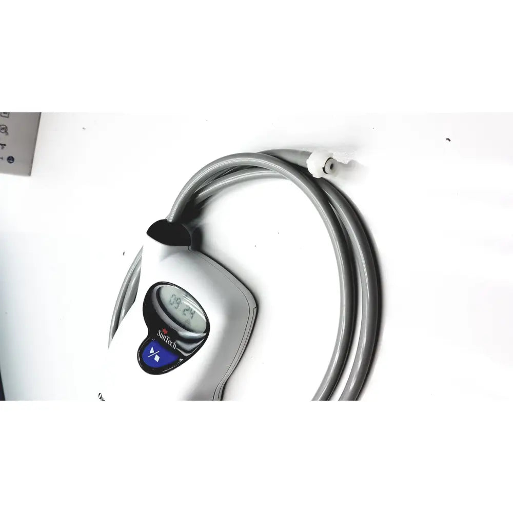 Silver suntech digital thermometer with curved gray hose and black clip for ambulatory blood pressure monitoring system
