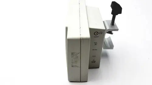 Beige plastic suntech medical tango+ patient monitor with black handle and metallic clamp for medical use