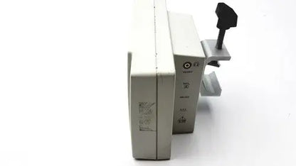 Beige plastic suntech medical tango+ patient monitor with black handle and metallic clamp for medical use