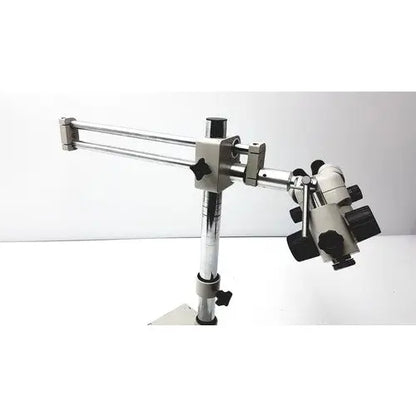 Silver and black metal super widefield microscope with adjustable arm featuring eyepieces 23mm swh10x focus knobs