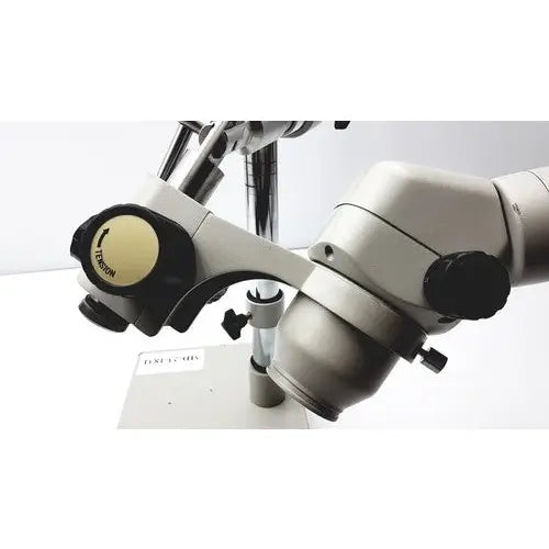 Silver and black dental surgical microscope with adjustable arms and labeled focus knob featuring eyepieces 23mm swh10x for super widefield microscope use
