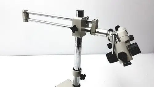Silver and black metal super widefield microscope with adjustable arm featuring eyepieces 23mm swh10x focus knobs