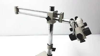 Silver and black metal super widefield microscope with adjustable arm featuring eyepieces 23mm swh10x focus knobs