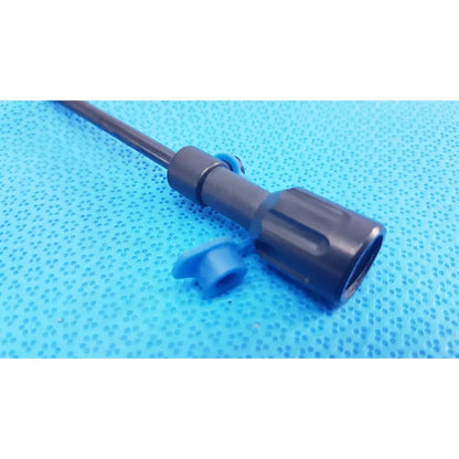 Black plastic surgical cannula sheath with textured grip and blue luer lock cap for secure medical use