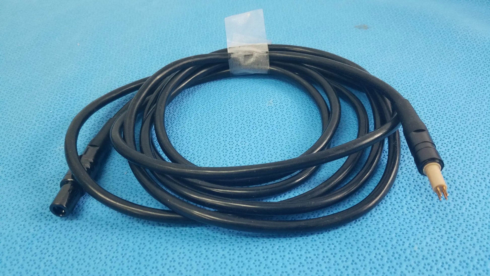 Black coiled surgical scher handpiece cable console power cord with black and beige connectors for medical equipment reuse