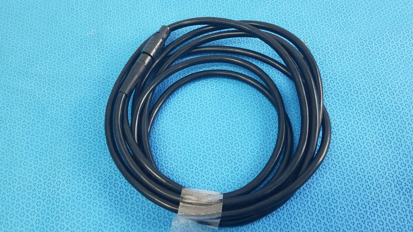 Black coiled surgical scher handpiece cable console connector with metallic connector and clear plastic tie for medical equipment