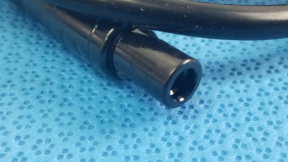 Black plastic cylindrical connector with a glossy finish for surgical scher handpiece cable console in medical equipment
