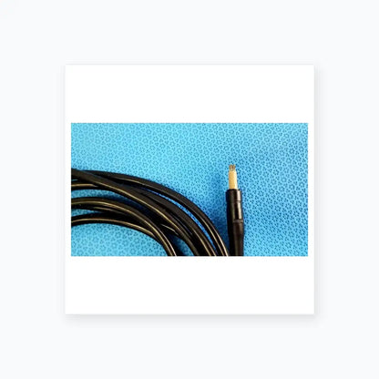 Black coiled surgical scher handpiece cable console connector with beige core and four metallic pins for medical equipment use