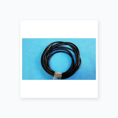 Black coiled surgical scher handpiece cable console connector with metallic connector and clear plastic tie for medical equipment