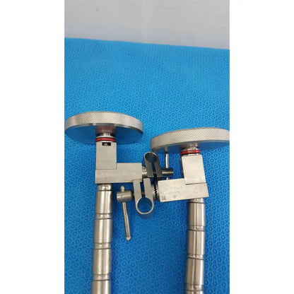 Stainless steel surgical snake flexarm with textured circular knobs and central adjustment for endoscope holding