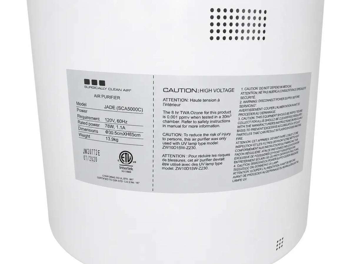 White cylindrical sca5000c surgically clean air purifier with label displaying specifications and safety warnings on back side