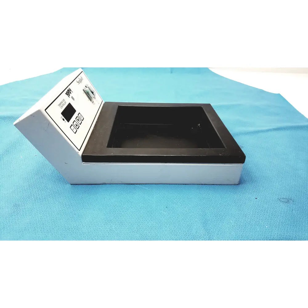 White and black surgipath digital tissue flotation bath with digital display control buttons and open compartment for laboratory use