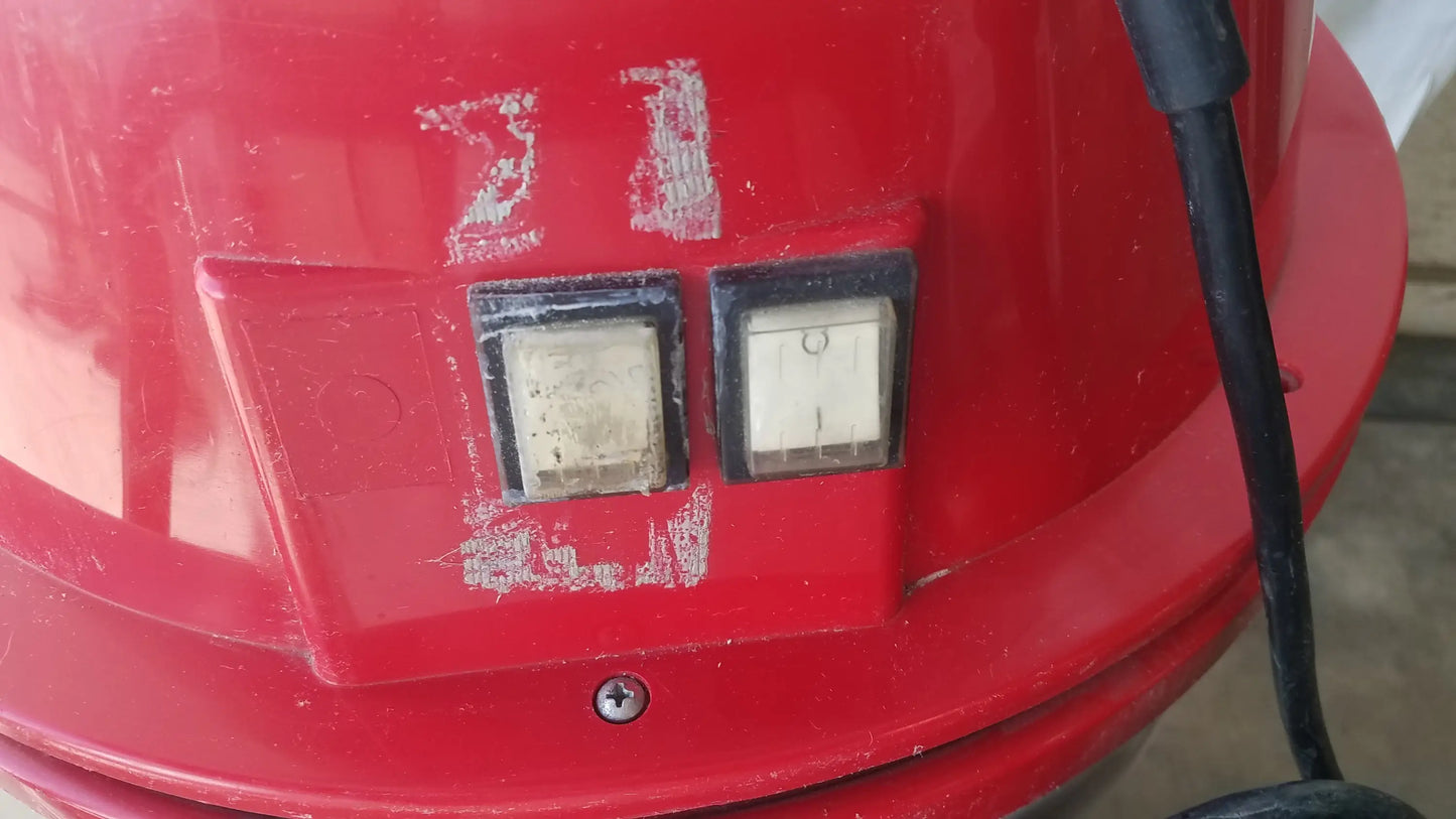 Red plastic fire extinguisher with control buttons and black hose shown with surtec system c72f1 wet dry vacuum cleaner