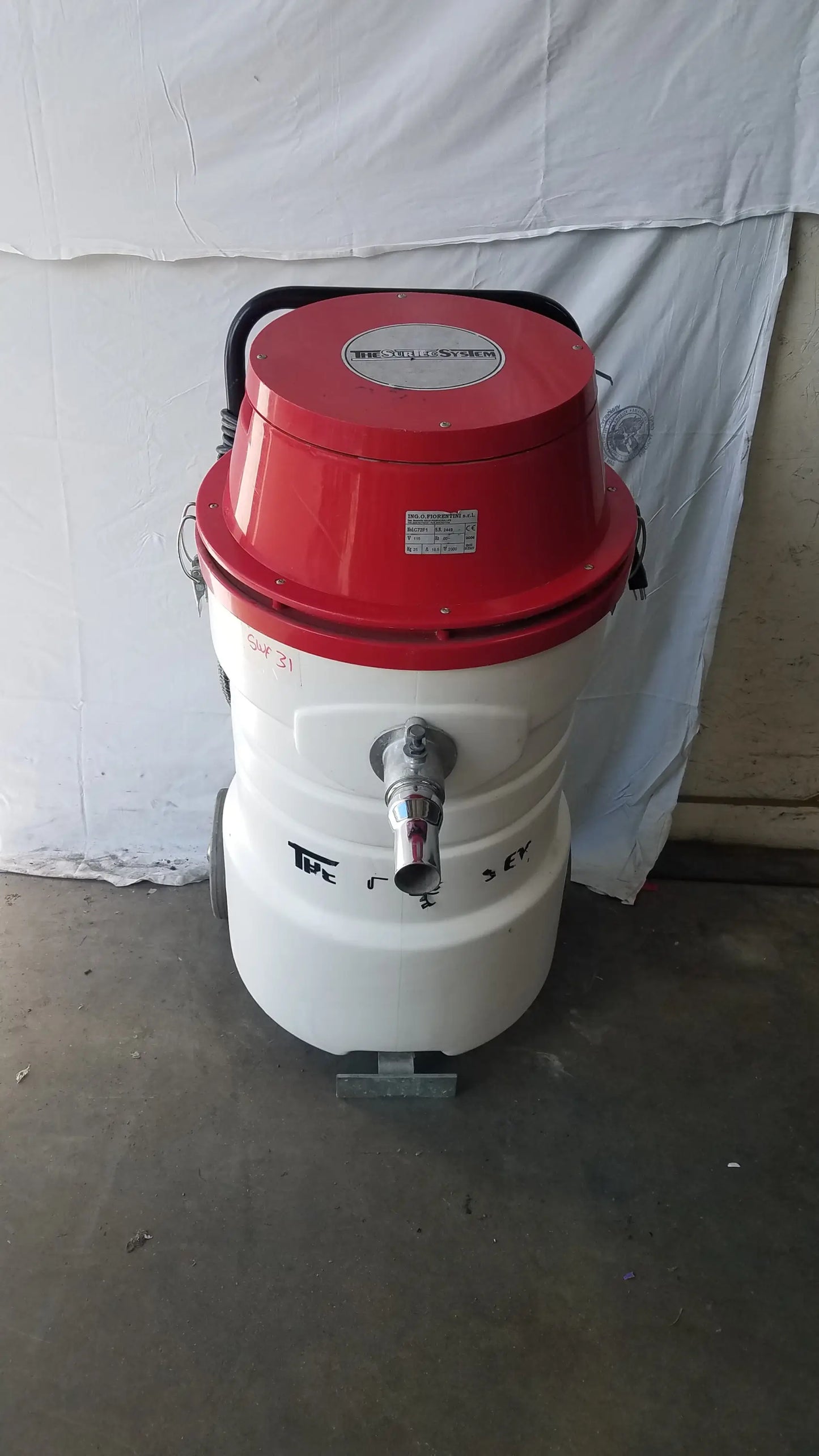Surtec system C72F1 red and white wet dry vacuum cleaner with cylindrical body and metal hose attachment 115V