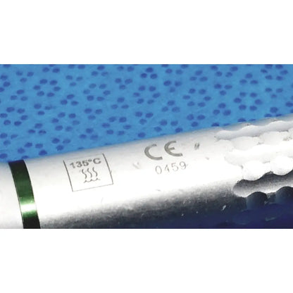Silver cylindrical sybronendo axxess spring-head handpiece with green band marked 135c and ce certification