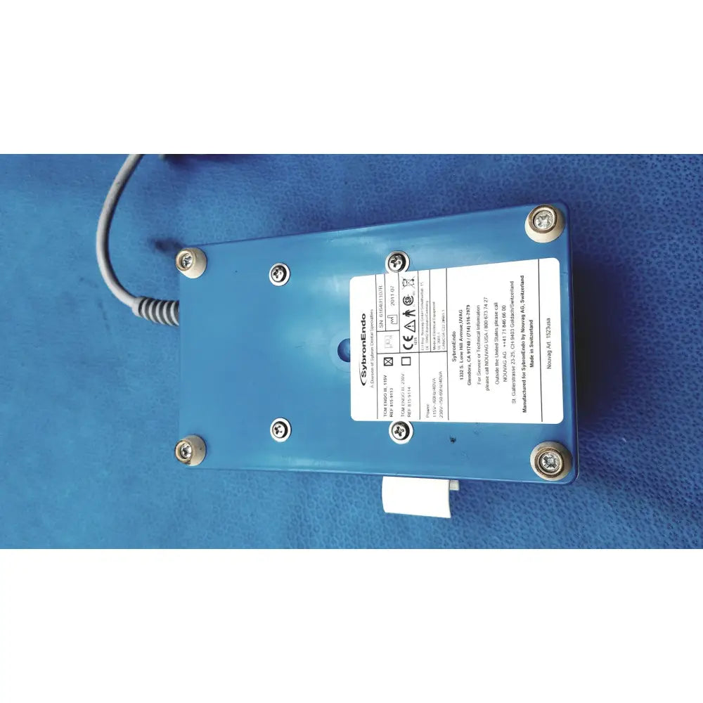 Blue rectangular SybronEndo TCM Endo III dental handpiece with silver screws and coiled gray cable attached