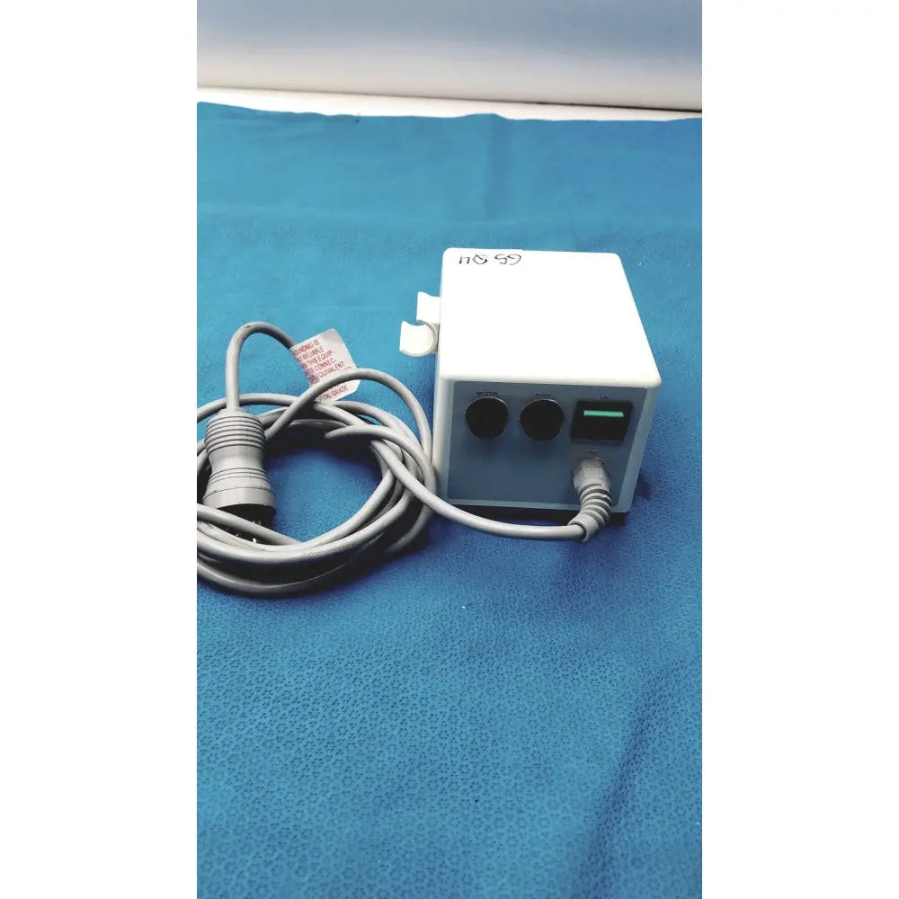 White rectangular power adapter with two black circular ports and a green usb port connected to gray cables for sybronendo tcm endo iii
