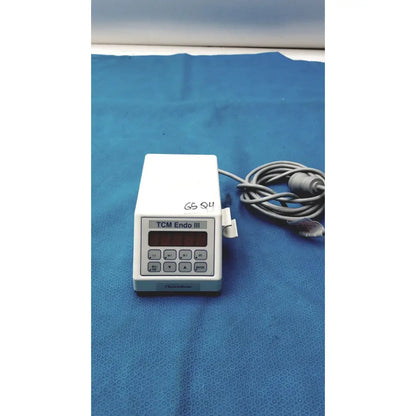White plastic sybronendo tcm endo iii medical device with digital display and control buttons for endodontic use