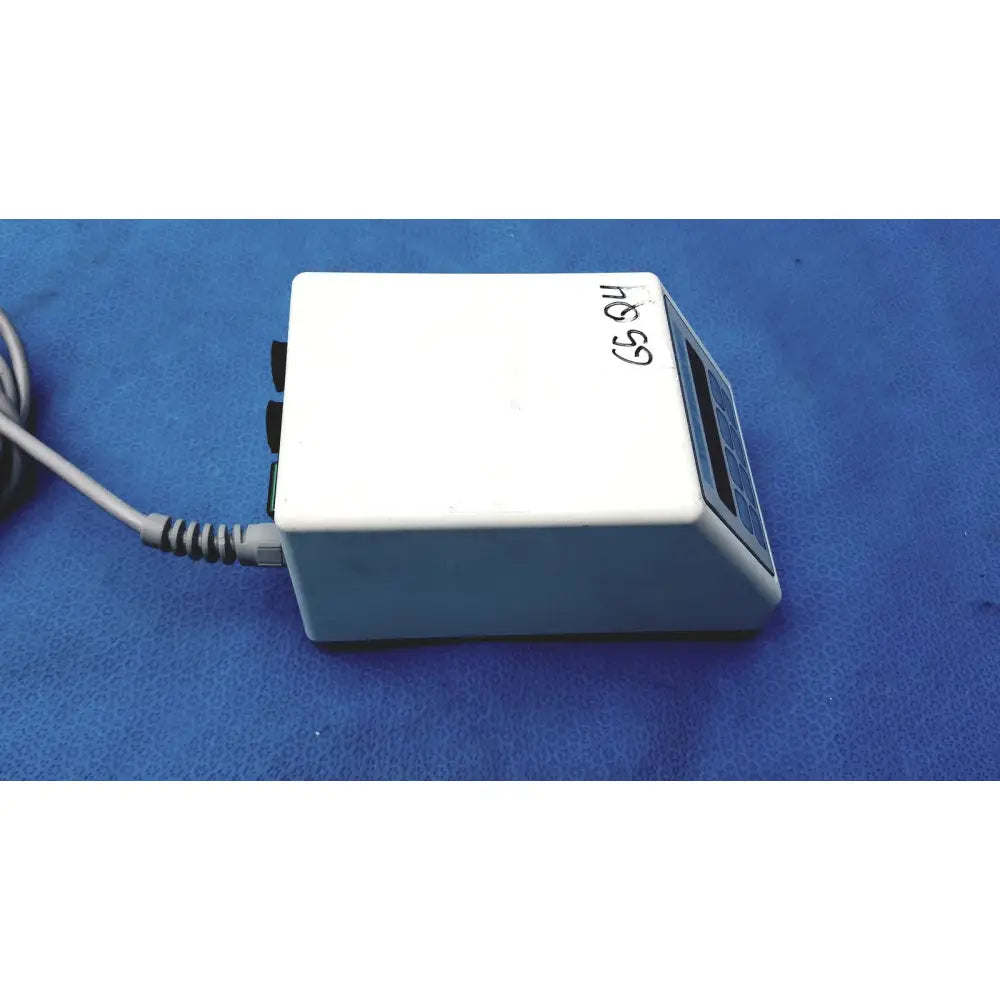White rectangular electronic sybronendo tcm endo iii device with digital display control buttons and gray coiled power cord attached