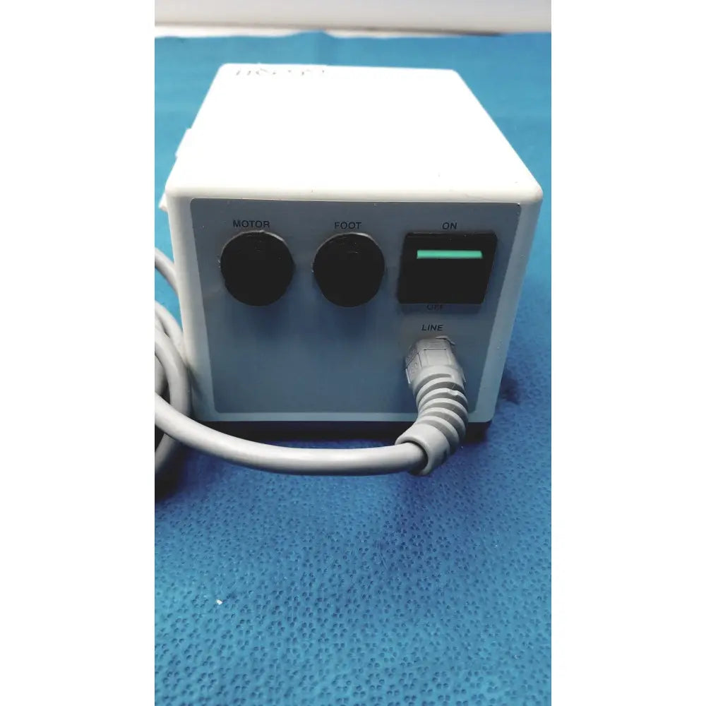 White rectangular electric foot massage machine with black controls and green power switch by sybronendo tcm endo iii