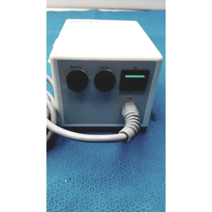 White rectangular electric foot massage machine with black controls and green power switch by sybronendo tcm endo iii