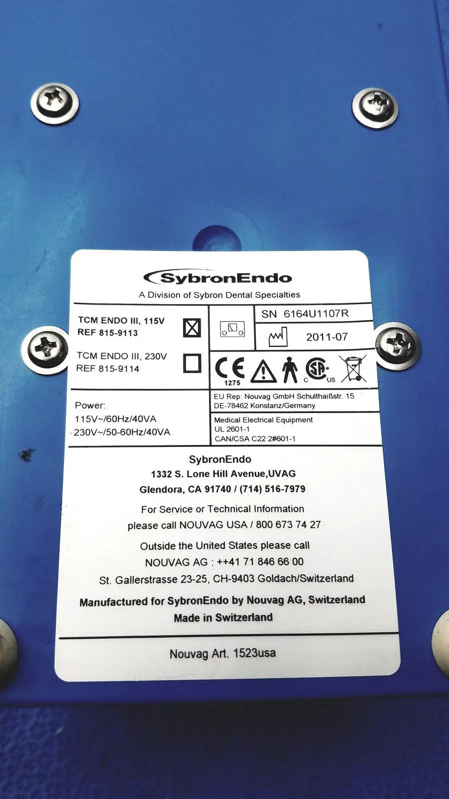 Blue sybronendo tcm endo iii medical device with silver screws and white label for dental root canal treatment