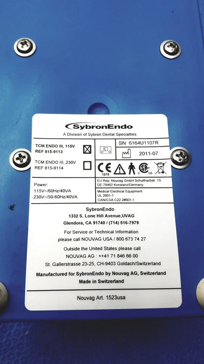 Blue sybronendo tcm endo iii medical device with silver screws and white label for dental root canal treatment