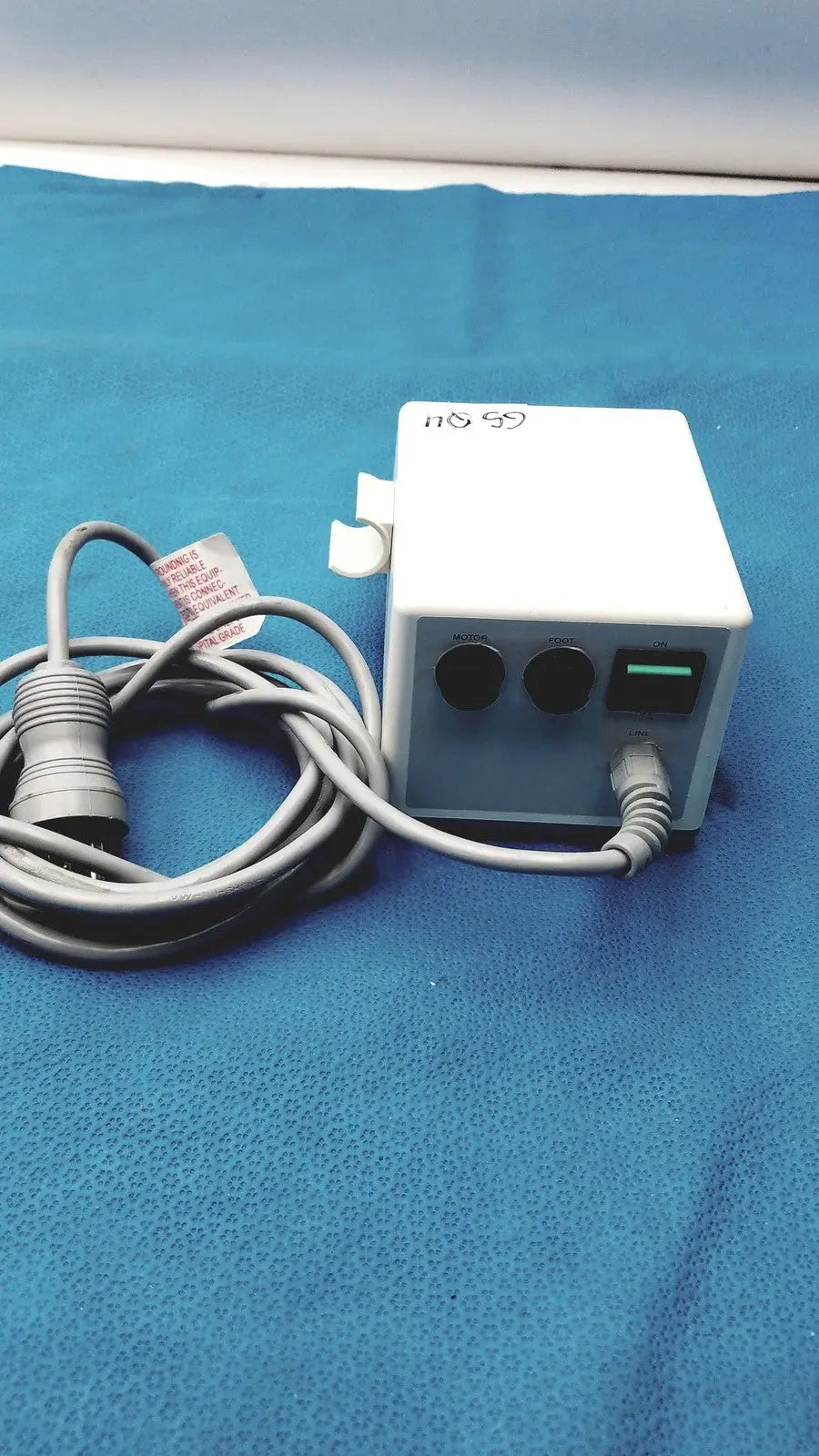 White rectangular power adapter with two black circular ports and a green usb port connected to gray cables for sybronendo tcm endo iii